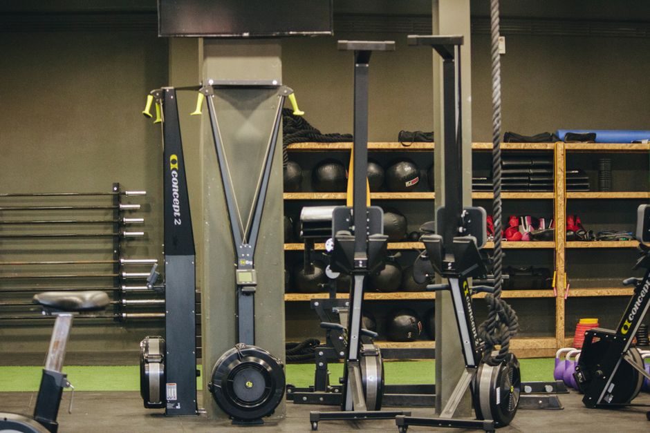 Interior de academia pequena com esteiras e equipamentos de musculação